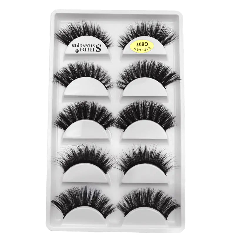 Glamorous 3D mink eyelashes in a transparent case, featuring a set of five pairs with varying lengths and styles for versatile makeup looks.