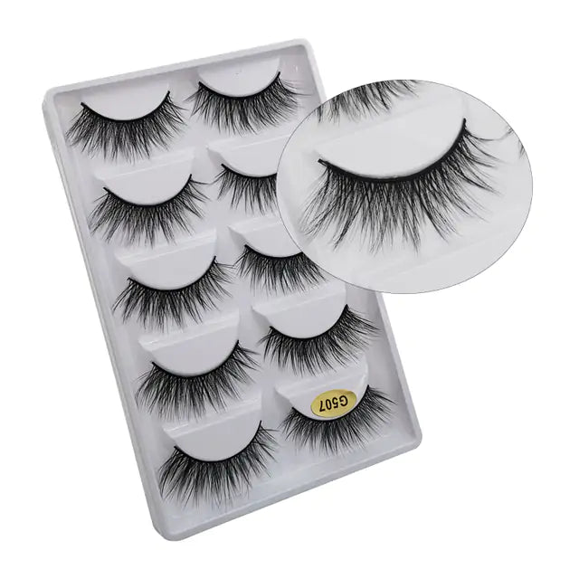 Glamorous 3D mink eyelashes in a clear tray showcased on a white background. These high-quality, fluffy lashes from My Store, Skin Deep Beauty&More, are perfect for enhancing eyes and creating a bold, volumized look.